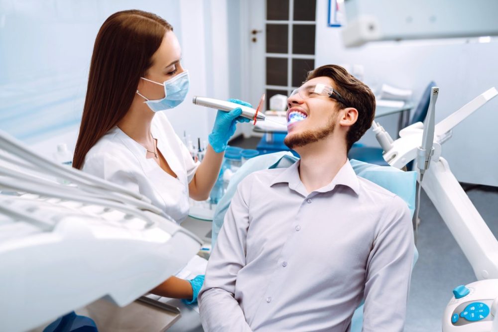 young-man-at-the-dentist-s-chair-during-a-dental-procedure-overview-of-dental-caries-prevention-
